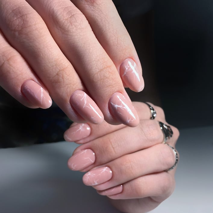 professional pink female manicure on nails close up